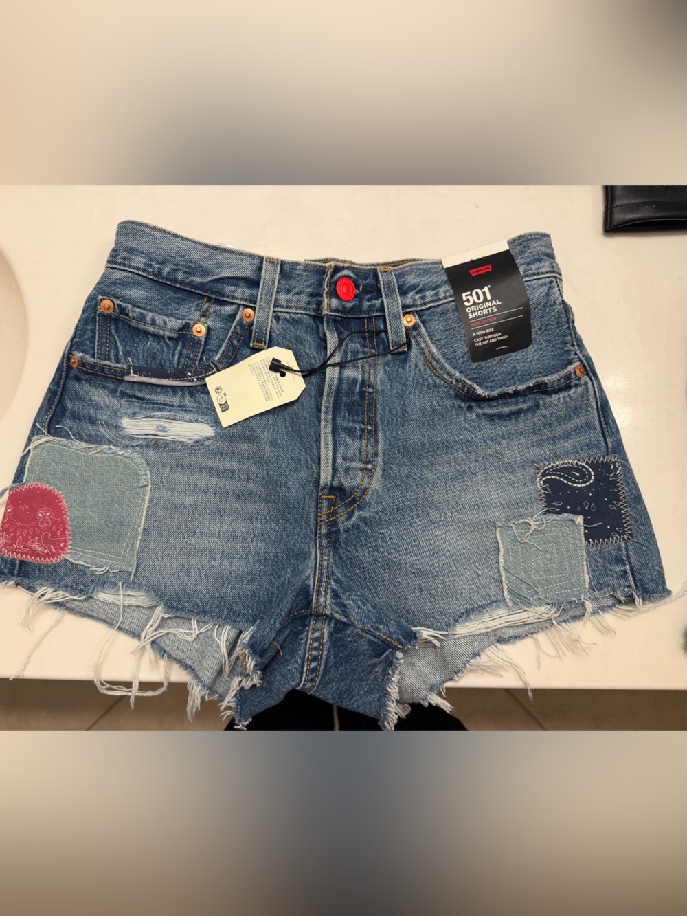 Levi's Mid Blue Distressed Cropped Denim Shorts with Patchwork and Red Button